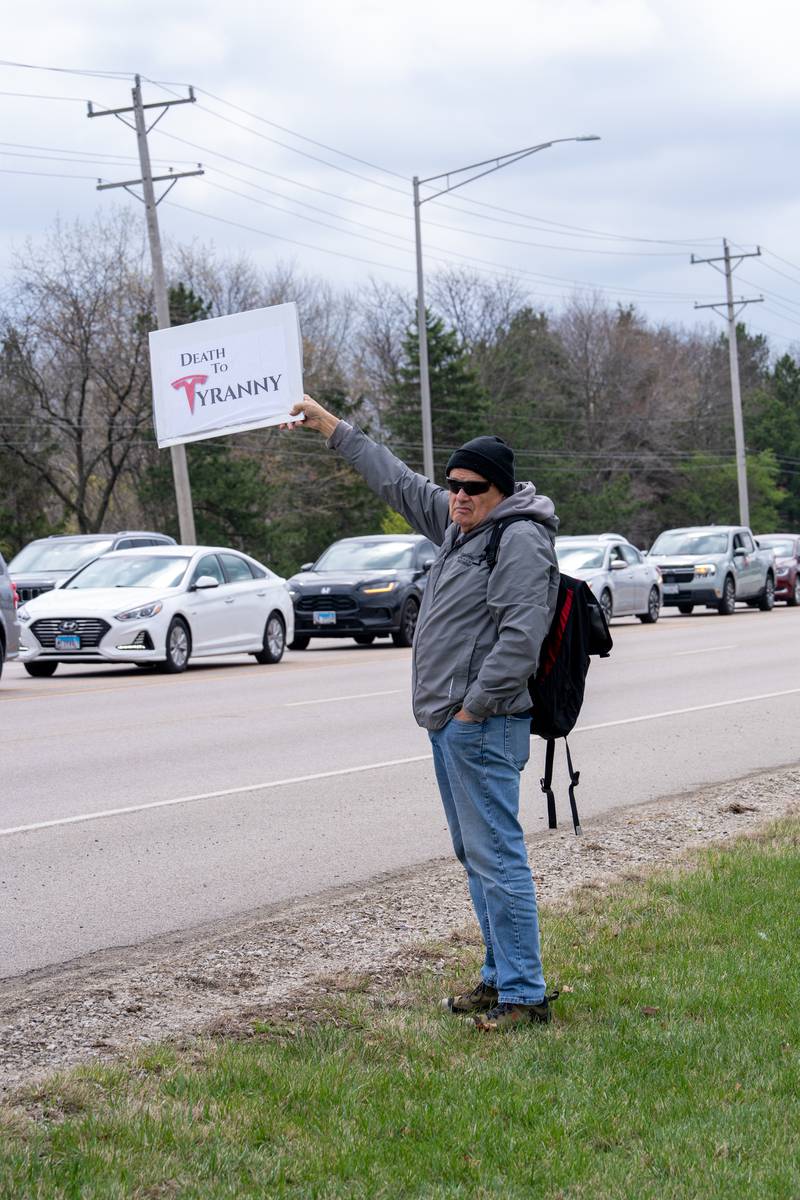 Protester stands along Randall Road in South Elgin, IL to protest their issues with President Donald J. Trump and his administration and Elon Musk involvement in US government affairs on Saturday April 19, 2025.  Hundreds of protesters participated in the latest Hands Off protest occurring in the Chicagoland area and the rest of the country.