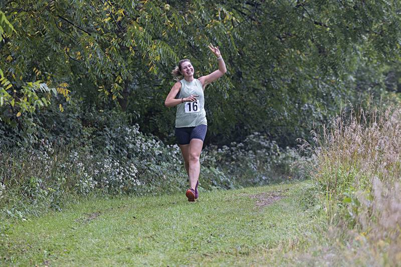 All smiles now but Lauren Pendergrass doesn’t know the terror awaiting her around the next turn as she runs in the Zom-G 5K fun run Saturday, Sept. 16, 2023 in Dixon.