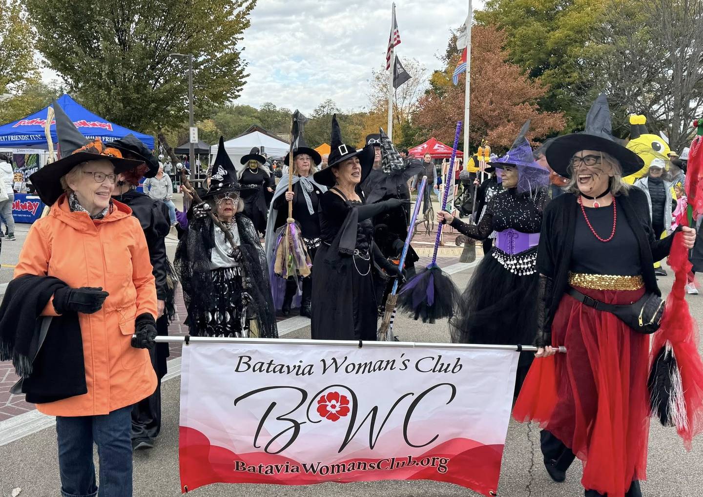Batavia Woman's Club members Ellyn Stewart, left, and Marsha Sikkema carry the banner in the Bat Fest parade last year after a traditional witches’ dance performance by several club members at the Peg Bond Center.