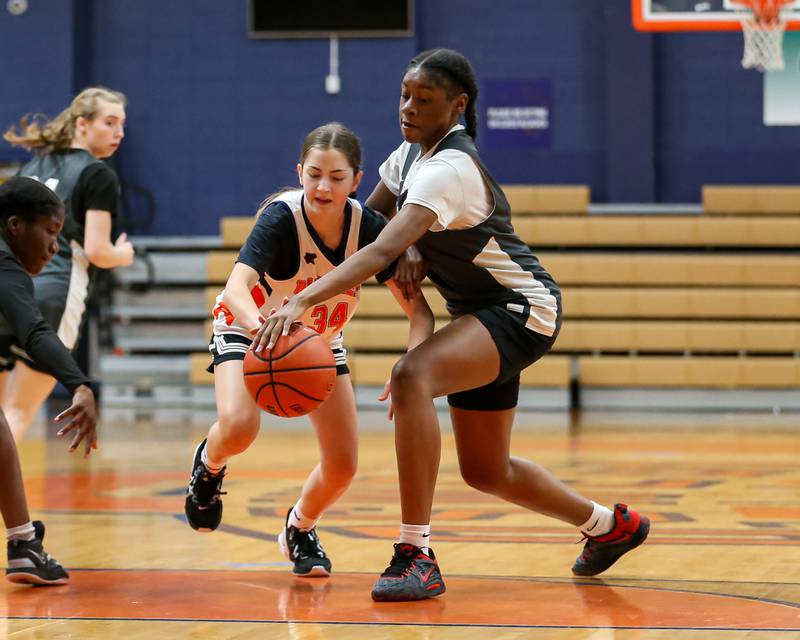 Dekalb's Brytasia Long (R) fights for possession of the ball at the Oswego Girls Basketball Shootout . June 30, 2023.