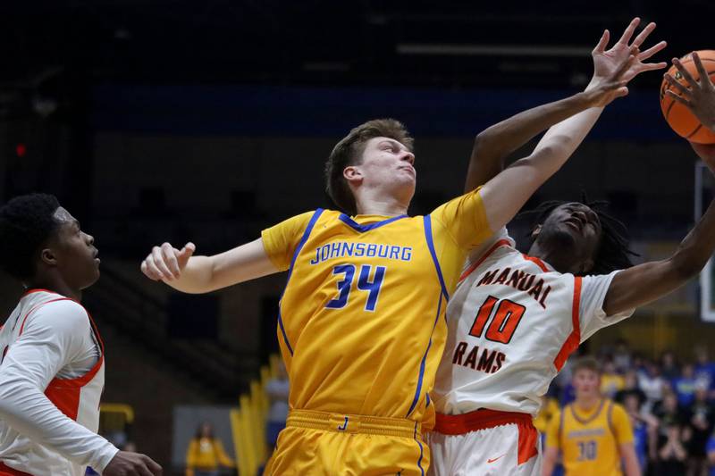 Johnsburg’s Danny Loud, center, battles Peoria Manual’s Jaquan Brown for the ball in boys IHSA Class 2A Supersectional basketball on Monday, Mar. 9, 2026, at Sterling High School in Sterling.