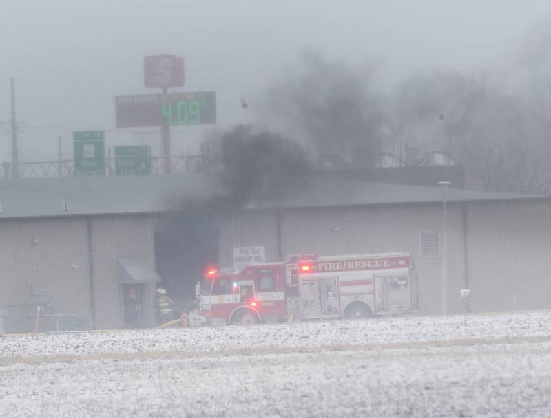 Peru firefighters work the scene of a structure fire at TDJ Group warehouse on Friday, Feb. 16, 2024 north of Peru. The fire began shortly after 11a.m. Fire departments from across the Illinois Valley are responding to the scene.