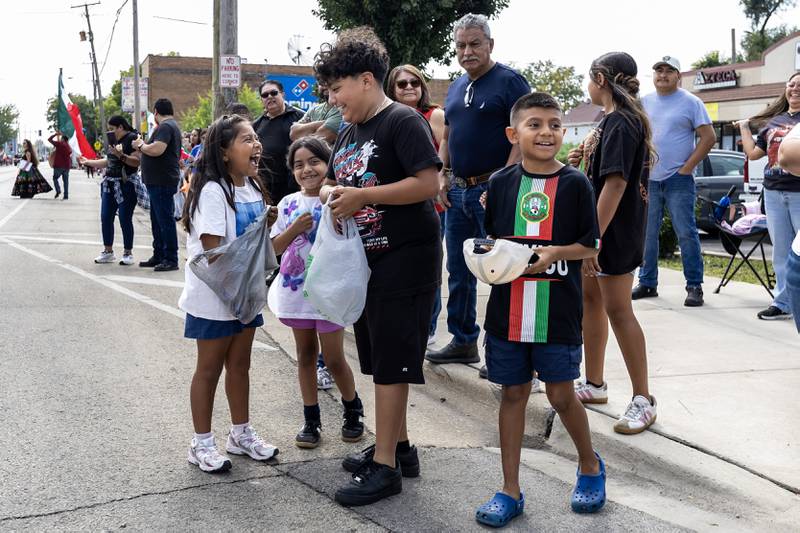 Natalie, Camila, Christian, and Manny Cerrillo smile after collecting candy during the City of Joliet Fiestas Patrias Mexican Independence Day Parade on Sept. 13, 2025.