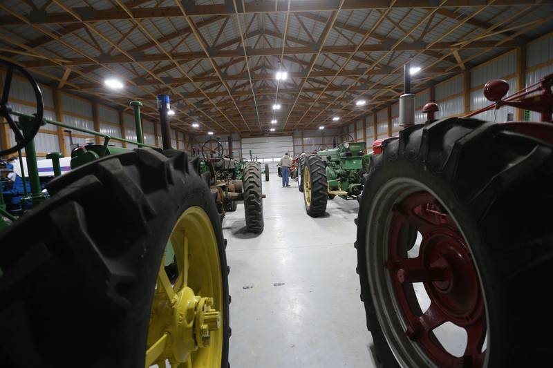 Bidders check out vintage tractorrs during the Pat and Sharon Broeren auction on Saturday, Dec. 13, 2025 at Dahl Real Estate Auctions and Appraisals in Walnut.
