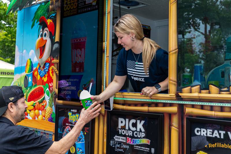 Mackenzie Han with Kona Ice serves a customer at the Hinsdale 4th of July Family Celebration.  July 4th, 2024.