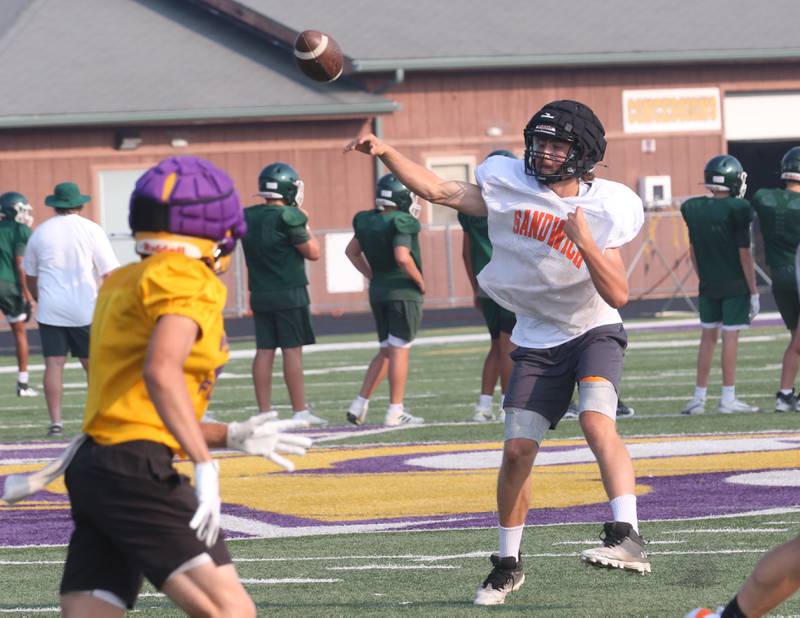 Sandwich quarterback Brady Behringer throws a pass against Mendota during a joint practice on Thursday, July 31, 2025 at Mendota High School.