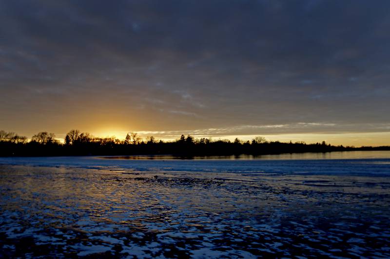 The sun sets over Crystal Lake  on Wednesday, Jan. 8, 2025, near Crystal Lake’s Main Beach.