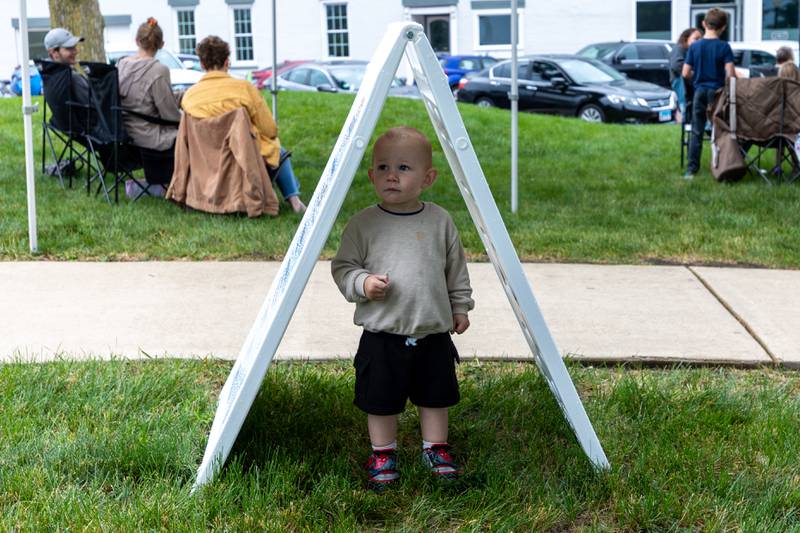 Everett Eckberg stands under sign at the annual Shrimp Fest on Saturday, June 7, 2025 at Rotary Park in Princeton.