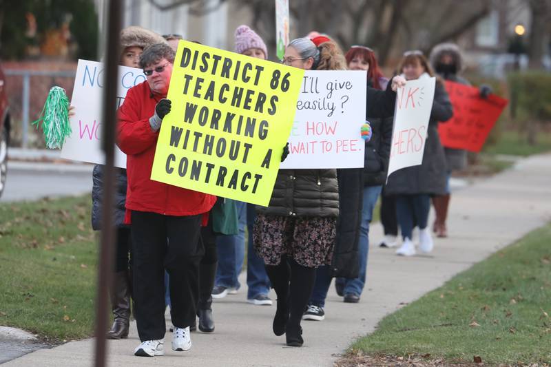 Teachers march outside District 86 Administrative Center on Monday in Joliet. District 86 teachers are currently working with a contract.