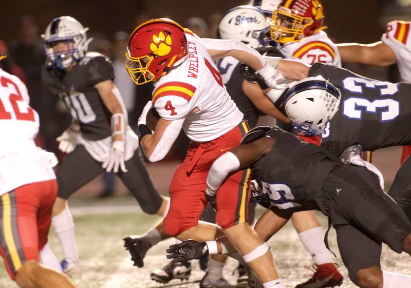 Batavia’s Charlie Whelpley runs the ball through the St. Charles North defense during a game at St. Charles North on Friday, Sept. 15, 2023.