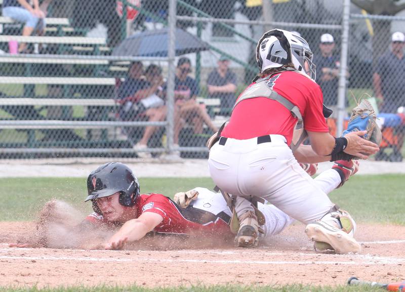 Spring Valley's Jaxon Pinter reacts after sliding across the plate against Burbank during the Central Regional Senior Baseball Regional tournament at J.A. Happ Field in Washington Park in Peru.