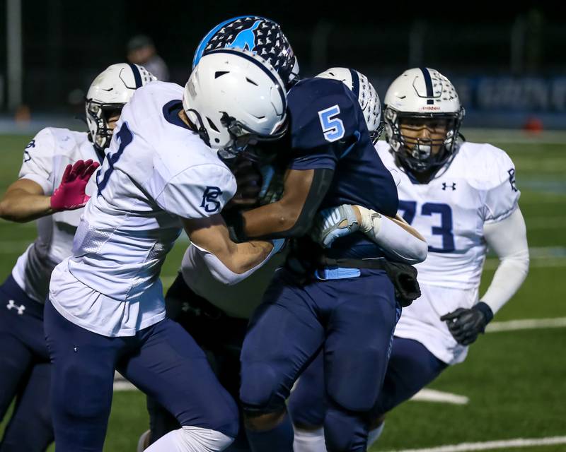 Plainfield South's Caden Pierceall (3) assists with the gang tackle of Downers Grove South's Kayden Smith (5) during Class 8A Playoff football game between Plainfield South at Downers Grove South on Friday, Nov 1, 2024  in Downers Grove.