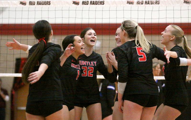 Huntley’s Red Raiders celebrate a two-set win over Burlington Central in varsity volleyball at Huntley High School in Huntley on Thursday, Oct. 24, 2024.