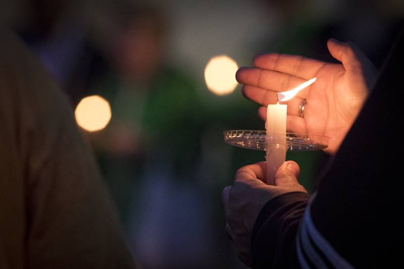 Shaw Local 2017 file photo – A candle is lit at the vigil on August 31, 2017 at the corner of First and Lincoln Highway in Dekalb.