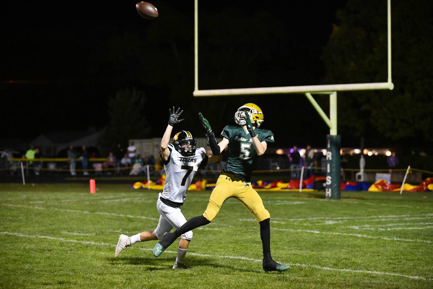Bishop McNamara's Richie Darr catches a touchdown pass under pressure from Herscher's Gaige Brown on Friday, Sept. 6, 2024, during the Fightin' Irish's 20-13 loss to Herscher.