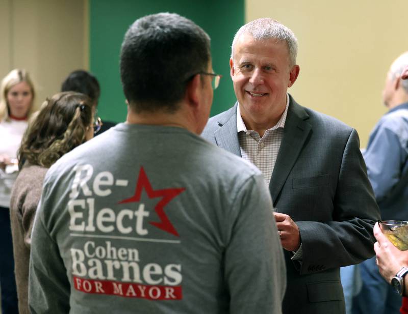 DeKalb Mayor Cohen Barnes, who is running for reelection, talks to a supporter Tuesday, April 1, 2025, during an election night watch party at Faranda's Banquets in DeKalb.
