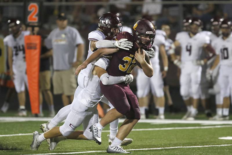 Richmond-Burton’s Steven Siegel pulls Marengo's Greg Baker and Owen Frederick as he runs with the ball during a Kishwaukee River Conference football game Friday, Sept. 9, 2022, between Richmond-Burton and Marengo at Richmond-Burton Community High School.