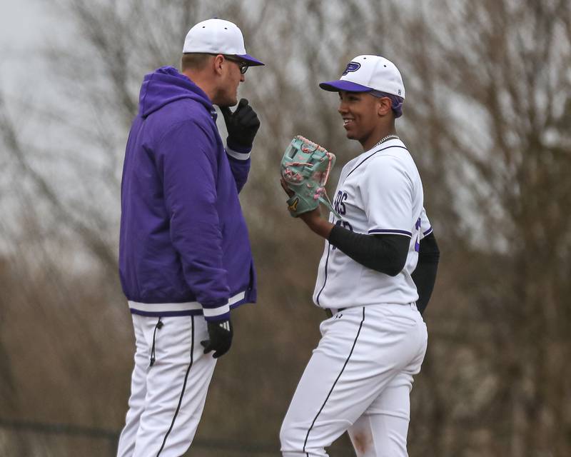 Plaino's head coach Nate Hill has a conversation on the mound with Jason Phillips (42) during baseball game between Sandwich at Plano on Thursday, April 9, 2025 in Plano.