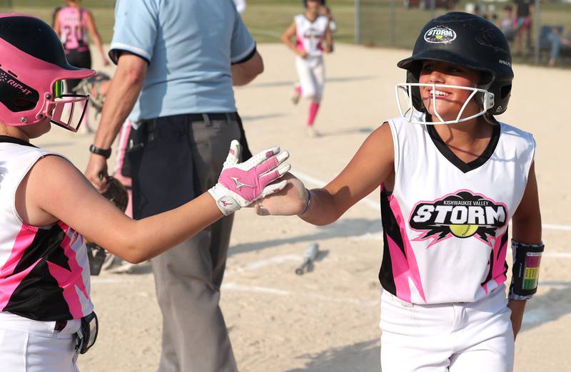 Kishwaukee Valley Storm 10u player Neve Crittenden is greeted by a teammate after scoring a run Wednesday, June 21, 2023, during a scrimmage game against the Poplar Grove Power at the Sycamore Community Sports Complex. The Kishwaukee Valley Storm is hosting the Storm Dayz tournament this weekend which draws about 70 teams and runs Friday through Sunday in Sycamore.