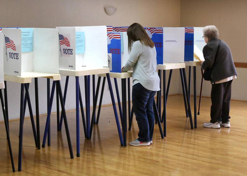 Voters cast their ballots Tuesday at the polling place in the Terrace Room at the Hopkins Park Community Center in DeKalb
