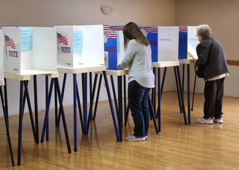 Voters cast their ballots Tuesday at the polling place in the Terrace Room at the Hopkins Park Community Center in DeKalb