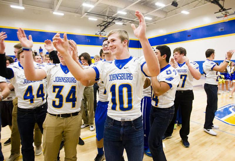 Johnsburg's Riley Buchanan (center) celebrates to the song "The Stroke" with the rest of the football team during Tuesday's pep rally at Johnsburg High School. The team is headed to Champaign on Friday for the Class 4A state championship against Rochester.