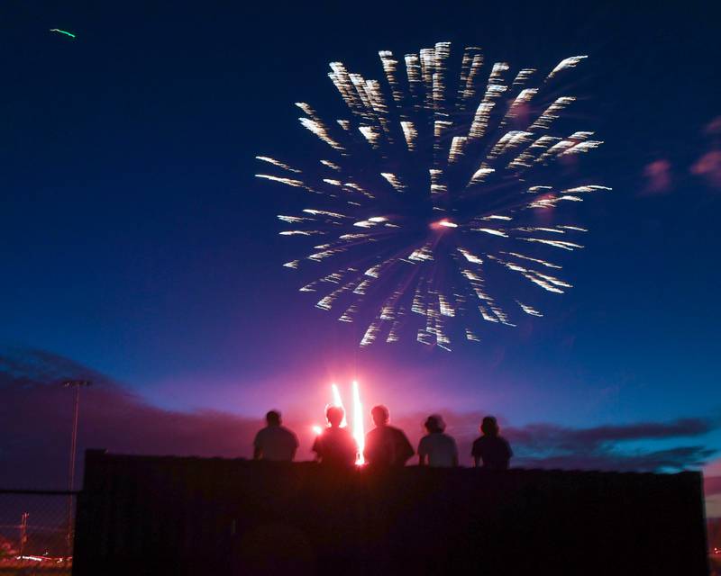 Young community members find an elevated location to watch the fireworks at Prairie Point Community Park in Oswego on Thursday July 4, 2024.