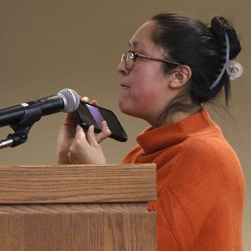 Ashbey Beasley, a survivor of the Highland Park mass shooting, plays a recording of the shooting on Tuesday, Feb. 21, 2023, during the public comment period at the McHenry County Board meeting about the proposed resolution opposing the Illinois gun ban and supporting its repeal in the Illinois State Legislature.