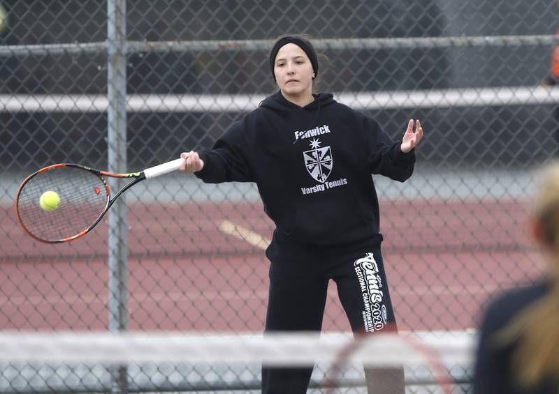 Fenwick’s Kate Trifilio returns the ball Thursday, Oct. 20, 2022, during during the first day of the IHSA State Girls Tennis Tournament at Schaumburg High School in Schaumburg.