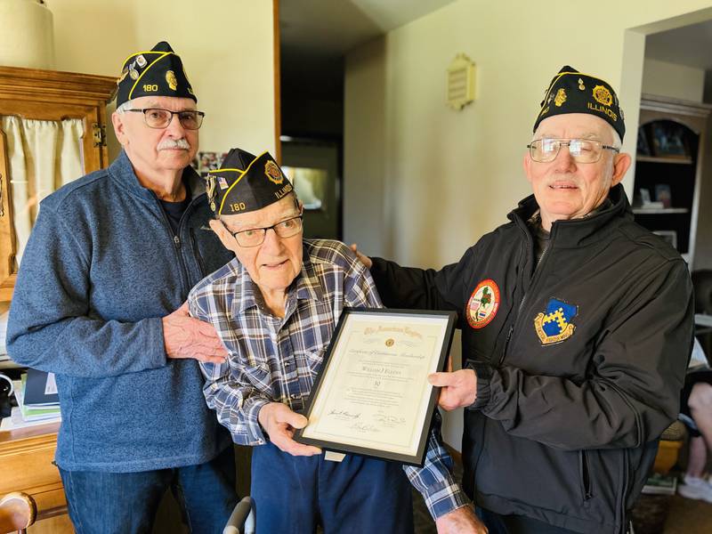 Bill Ellena, a Korean War era veteran, received a 50-year Certificate of Continuous membership in the American Legion from local representatives. (Left) Doug Ossola and Bill Haage (right) honor Bill Ellena (middle) with the certificate.