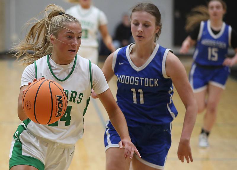 Crystal Lake South's Gracey LePage drives the baseline against Woodstock's Emma Douglas during the IHSA Class 3A Woodstock North Regional championship girls basketball game on Thursday, Feb. 19, 2026, at Woodstock North High School.