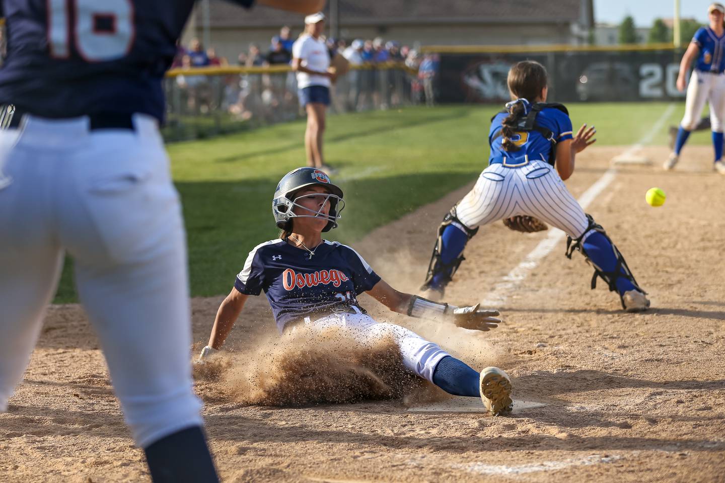 Oswego's Kaylee LaChappell (11) slides into home for the winning run in their Class 4A Plainfield North Sectional final softball game against Wheaton North. May 31th, 2024.