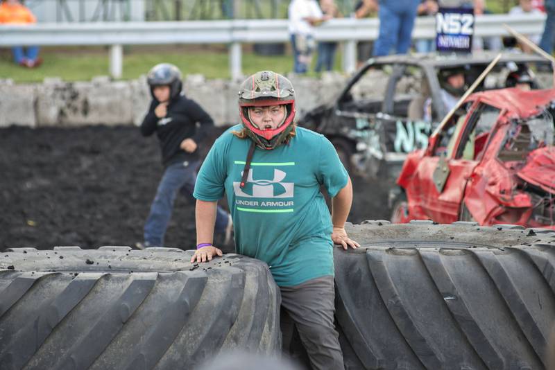 Evan Walker gets away from his demo car after a gas leak was detected in an adjacent car during the 18 and under derby.