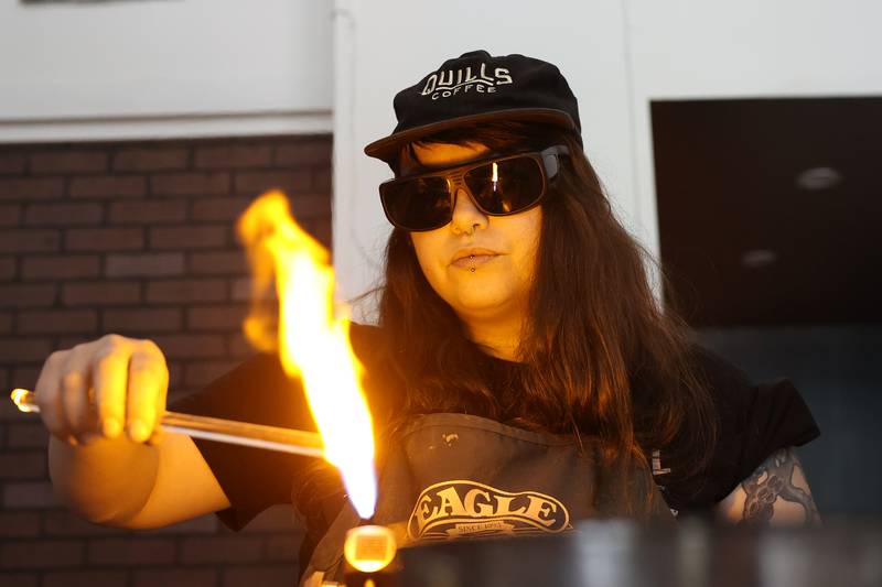 Angelica Cristal works on a glass pendent at her shop. Angelica is opening her own glass art business in the former Regis Glass Art Space in Downtown Joliet.