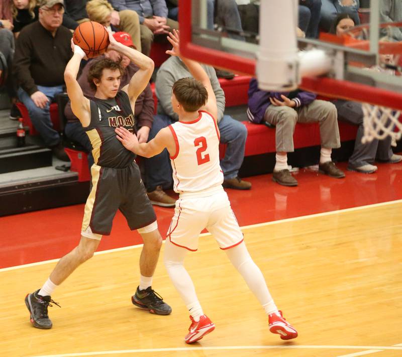 Morris's Caston Norris looks to pass the ball around Ottawa's Huston Hart on Wednesday, Jan. 3, 2024 at Kingman Gym.