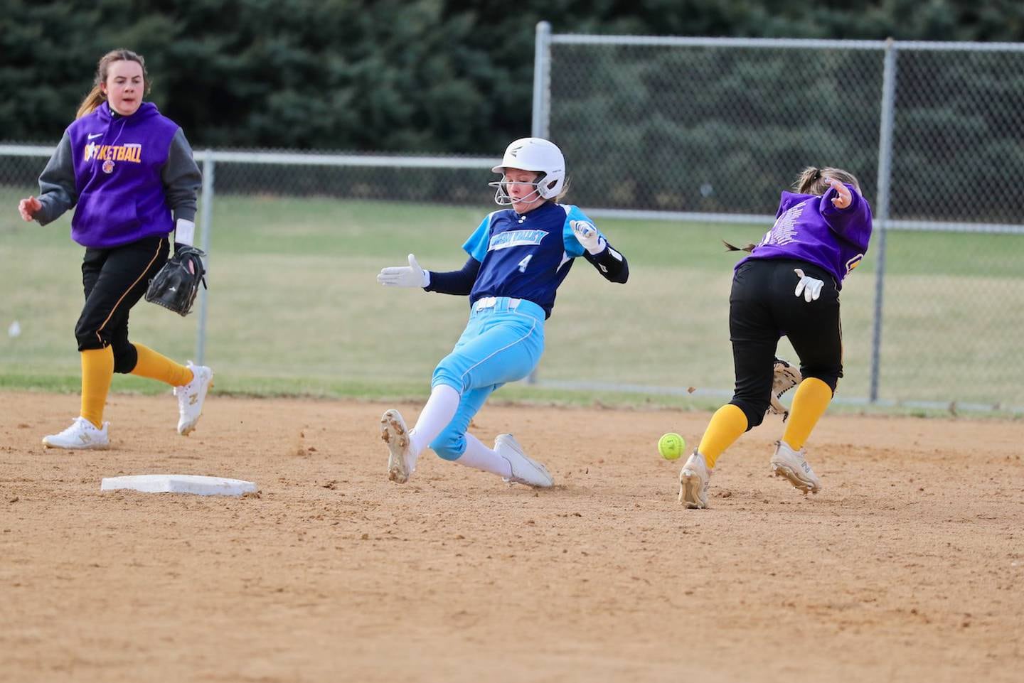 Bureau Valley's McKinley Canady slides in safely at second base as the ball eludes the Mendota fielder Monday at Manlius.