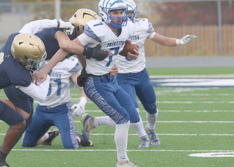 Princeton quarterback Gavin Lanham is brought down By a pair of Central Catholic players during the Class 3A playoffs on Saturday, Nov. 1, 2025 at Central Catholic High School in Bloomington.