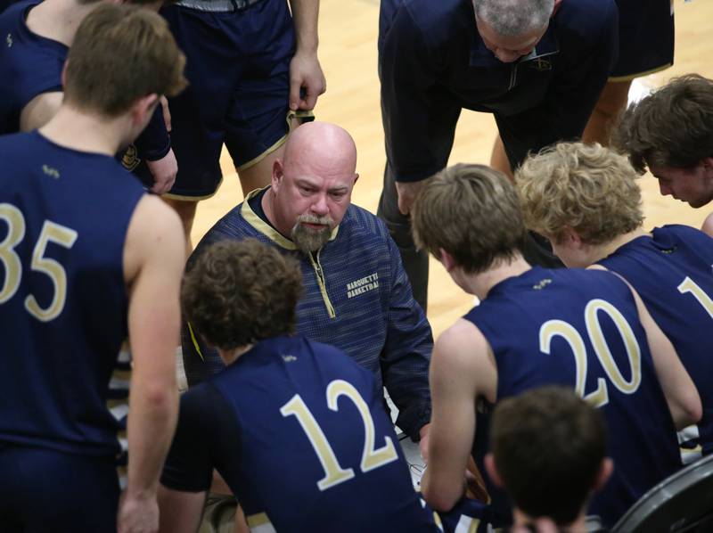 Marquette head boys basketball coach Todd Hopkins talks to his team during a time out in the Tri-County Conference championship on Friday, Jan. 27, 2023 at Putnam County High School.