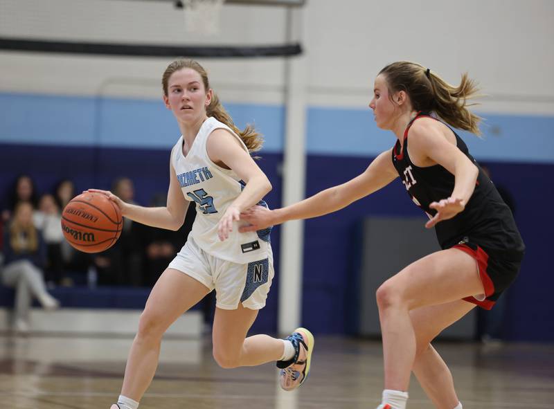 Nazareth's Mary Bridget Wilson (15) drives to the basket during the girls varsity basketball game between Benet and Nazareth academies on Wednesday, Jan. 3, 2023 in La Grange Park, IL.