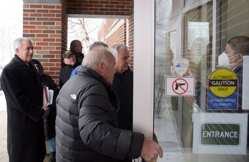Director of Elections Raymond Esquivel, right, instructs candidates that they can come in out of the snow during the first day of candidate filing at the Kane County Clerk’s office Monday, March 7, 2022 in Geneva.
