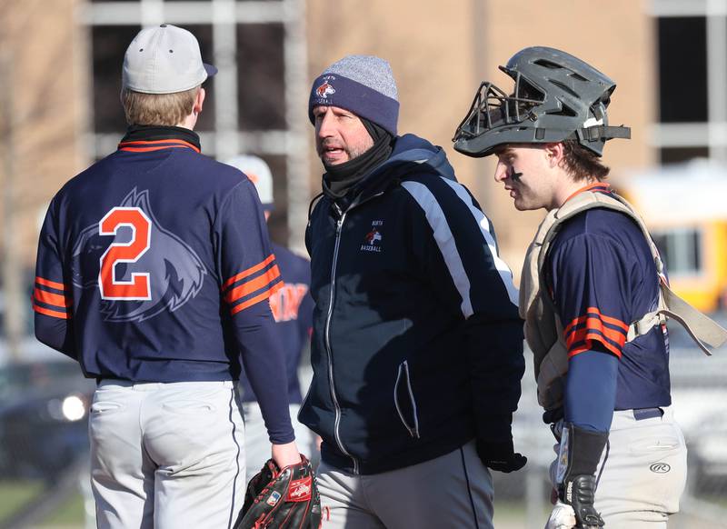 Naperville North head coach Jim Chiappetta talks to pitcher Max Steele (left) on a visit to the mound Tuesday, April 15, 2025, during their game at DeKalb High School.