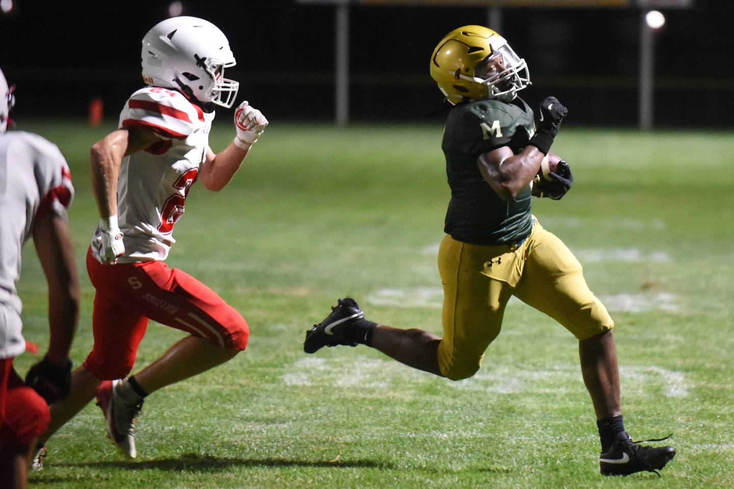 Bishop McNamara's Julius May, right, runs past Streator's Quentin Stevens during a Week 0 scrimmage at Bishop McNamara Friday, Aug. 22, 2025.