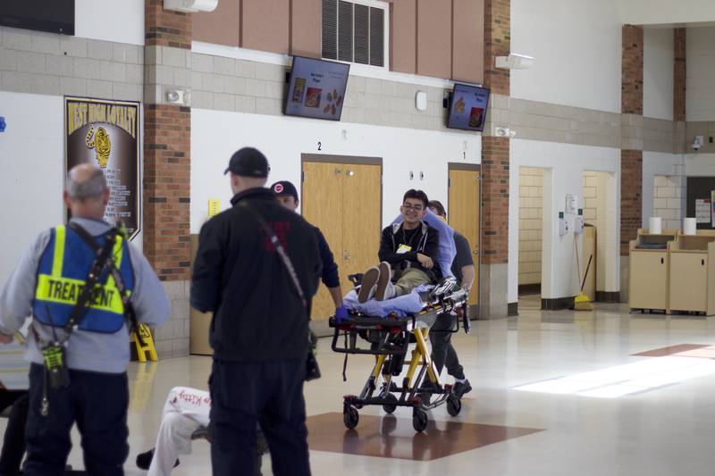 A student actor on a gurney inside Joliet West High School on Tuesday, March 25, 2025, for a staged emergency drill simulating the aftermath of a gas explosion.