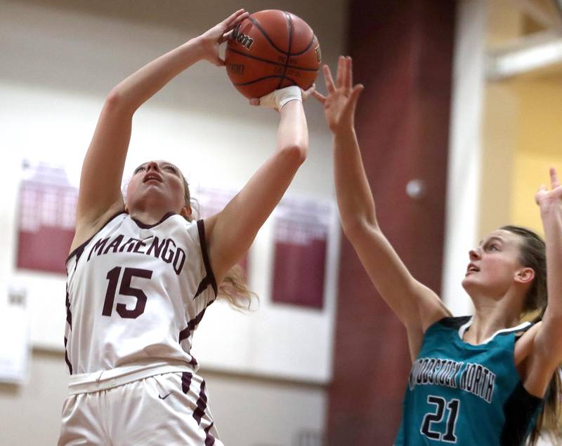 Marengo’s Gianna Almeida, left, shoots as Woodstock North’s Isabella Borta defends in girls basketball at Marengo on Thursday.