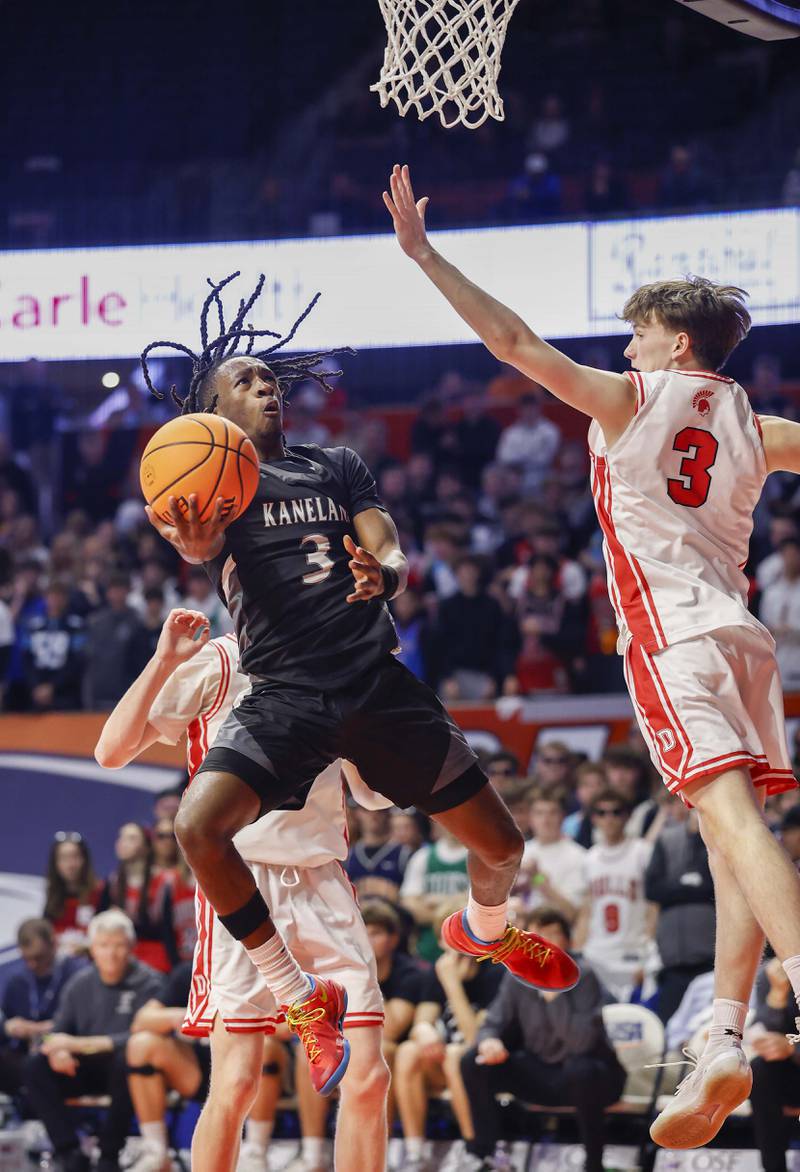 Kaneland's Marshawn Cocroft (3) drives to the hoop past Deerfield's Charlie Yellen (3) during the IHSA Class 3A boys basketball state semifinal Friday, March 13, 2026 at the State Farm Center in Champaign.