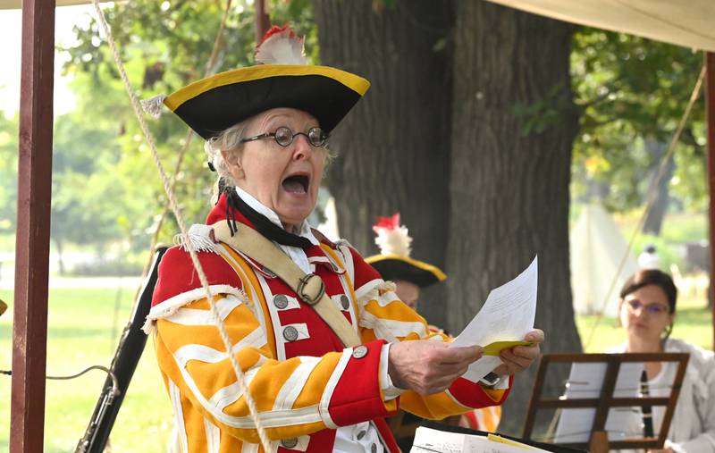 Center, Pamela Kundert of Lake Geneva, Wisconsin addresses the audience between musical numbers as part of Colonel Webb's Officers Band of Musick at Cantigny Park in Wheaton on Sept. 8, 2024.