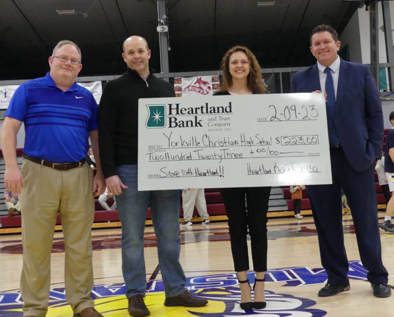 Pictured from left are Tim Schnyders from Yorkville Christian High School; Ryan Kastner, Heartland Bank Aurora senior lender; Jen Vandermeir, Heartland Bank Newark retail manager; and Aaron Sovern from Yorkville Christian High School.