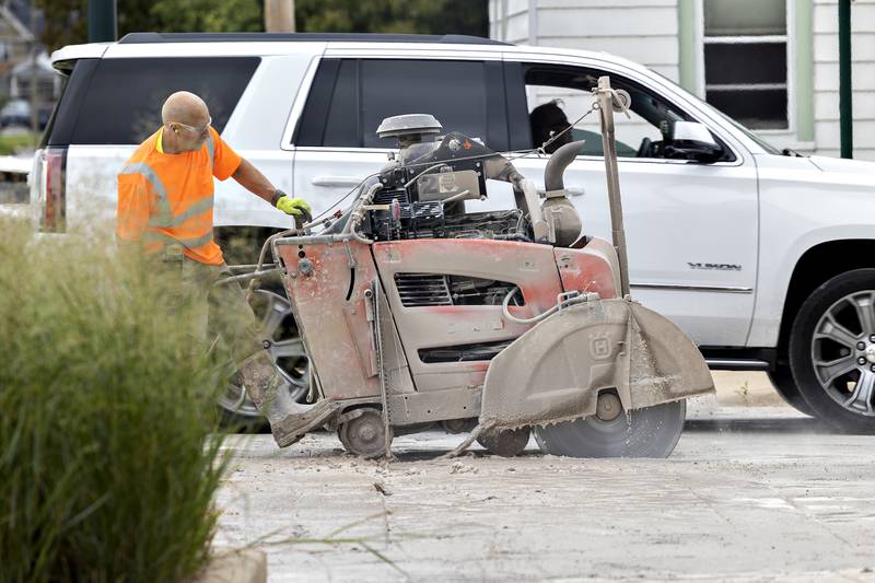 A Helm Construction crew member cuts into the crosswalk at Peoria and Second Street in Dixon Thursday, Aug. 21, 2025. The intersection is one of seven the crew is upgrading.