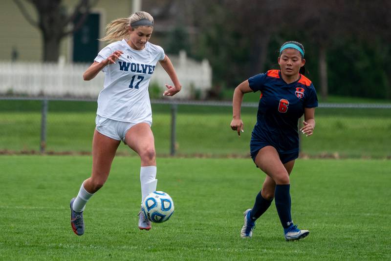Oswego East's Erika Smiley (17) plays the ball against Oswego’s Selah Smith (6) during a soccer match at Oswego High School on Monday, May 2, 2022.