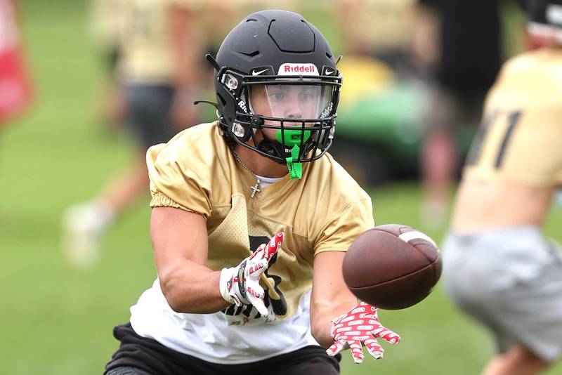 Sycamore's Kayden Galto makes a catch Monday, Aug. 8, 2022, at the school during their first practice ahead of the upcoming season.